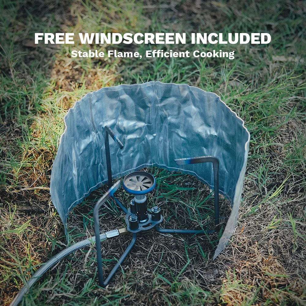 Portable stove with a free windscreen on grass, promoting stable flame and efficient cooking.