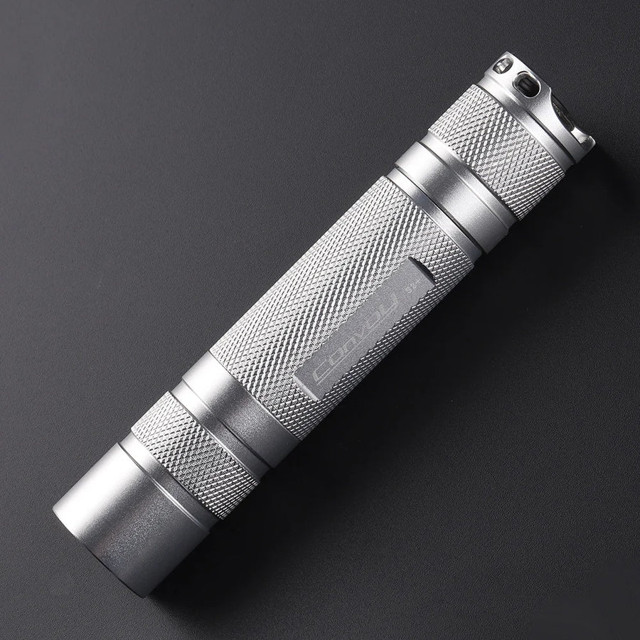 Silver flashlight on a dark gray background