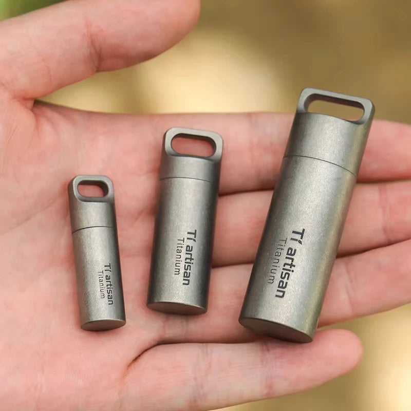 Three metallic cylindrical objects with 'Tiartisan' branding on a hand.