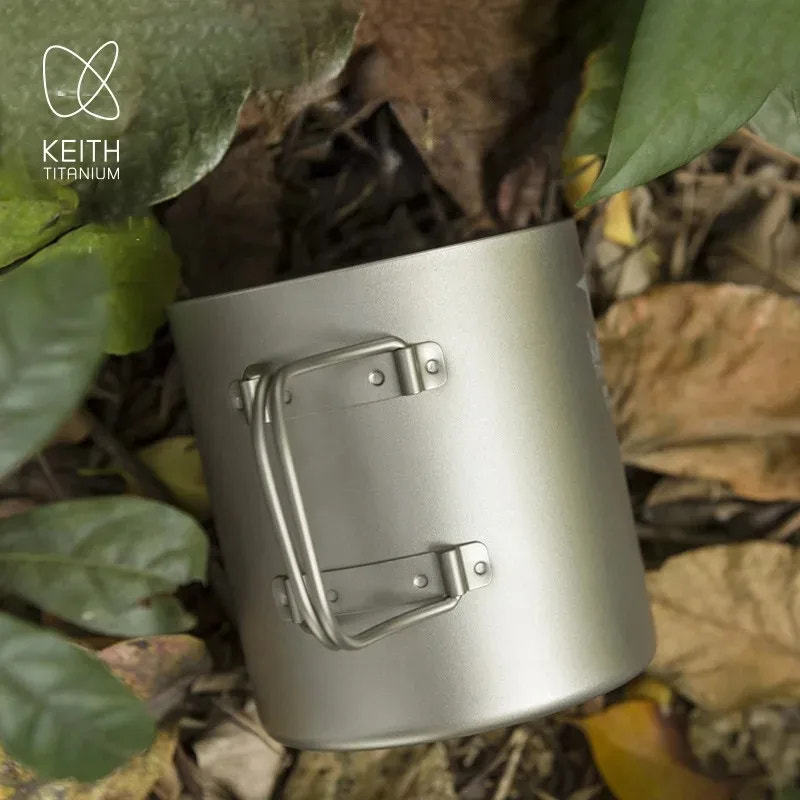titanium mug with handle on a natural leafy background, featuring Keith Titanium logo.