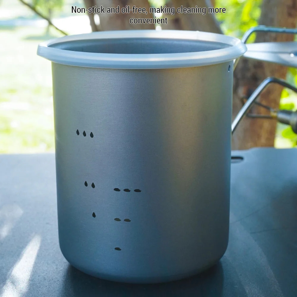 Metal pot with text about non-stick and oil-free properties on a blurred natural background