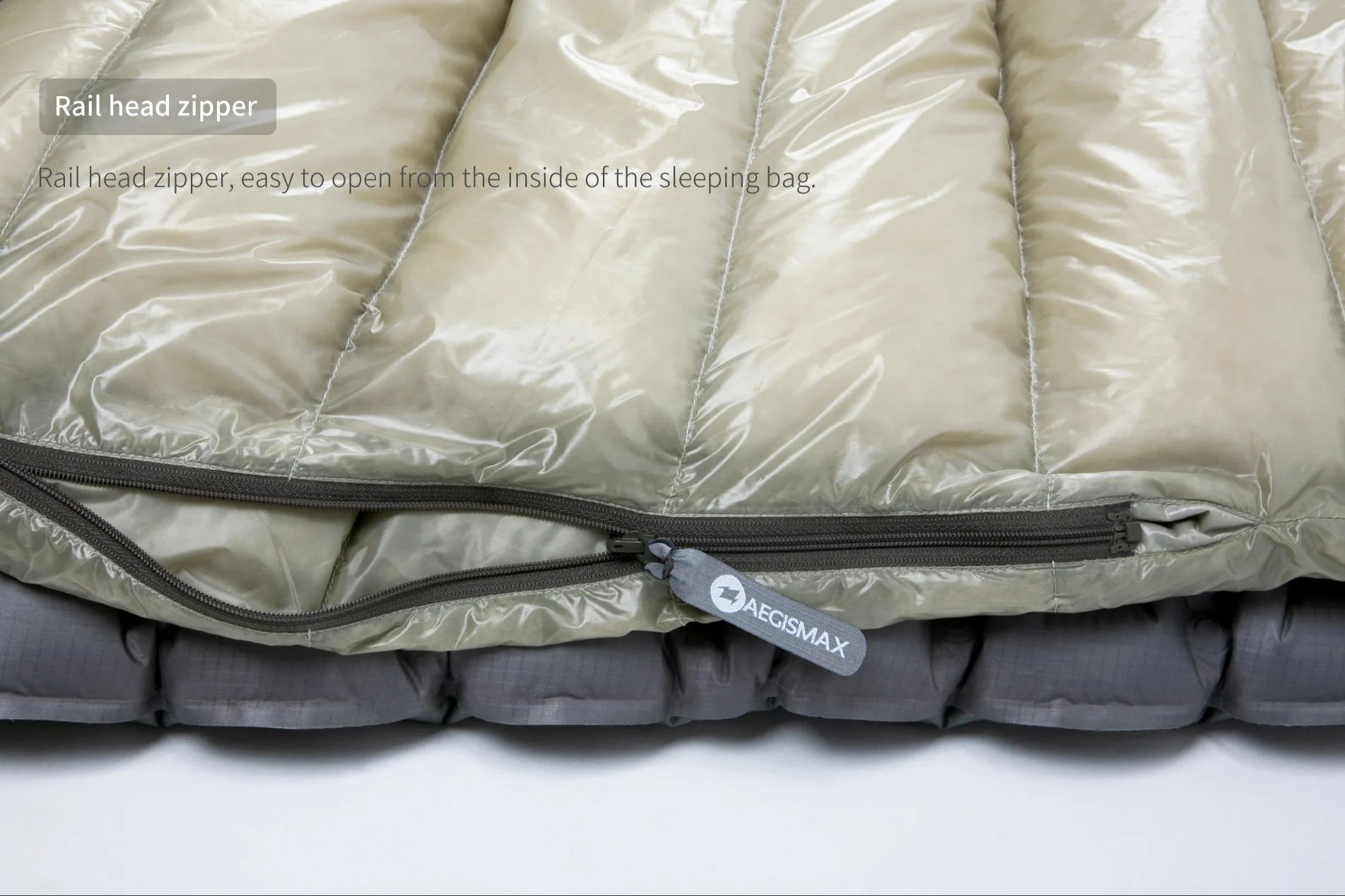 Close-up of a sleeping bag with a rail head zipper on a white background