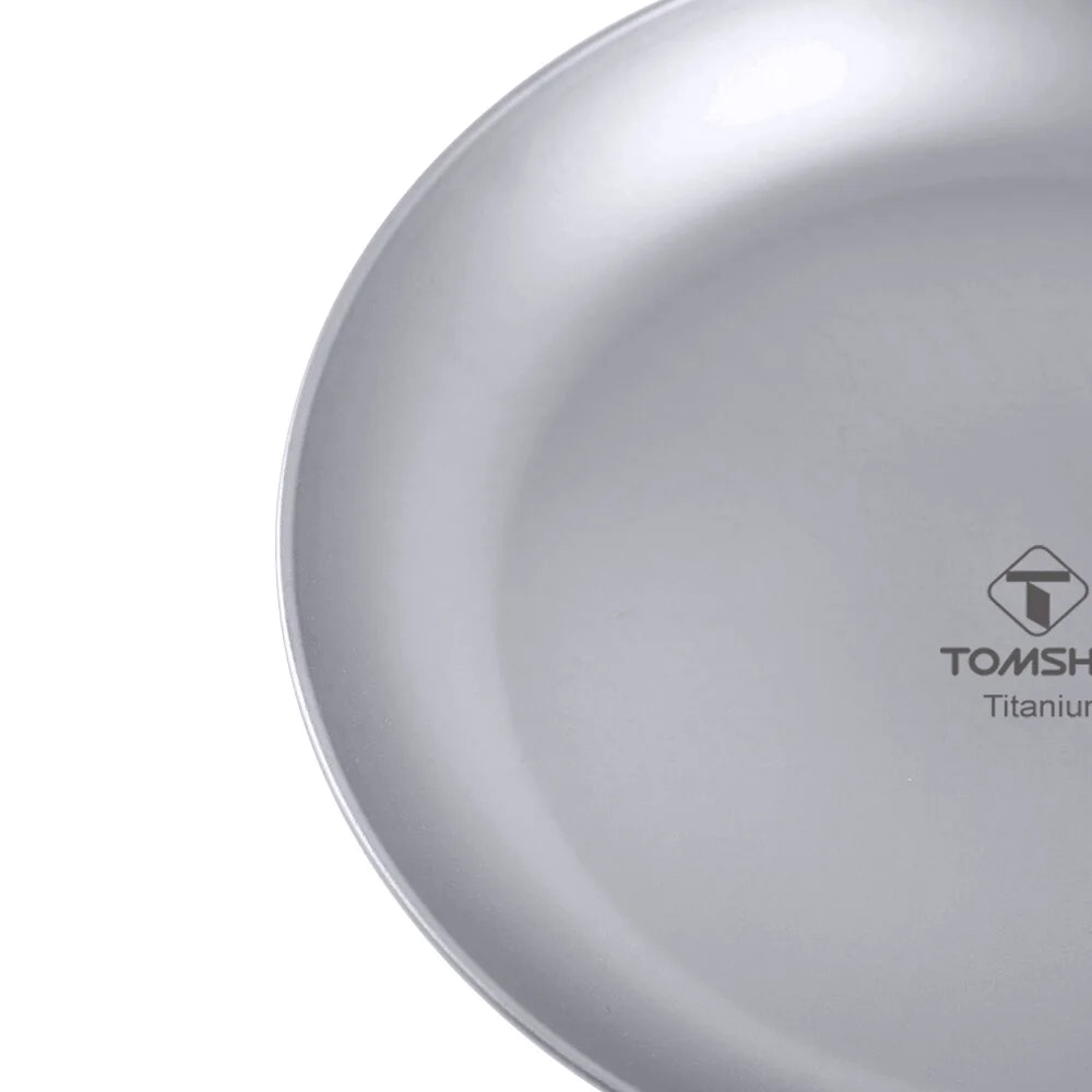 Close-up of a titanium plate with TOMSHOO logo on a white background