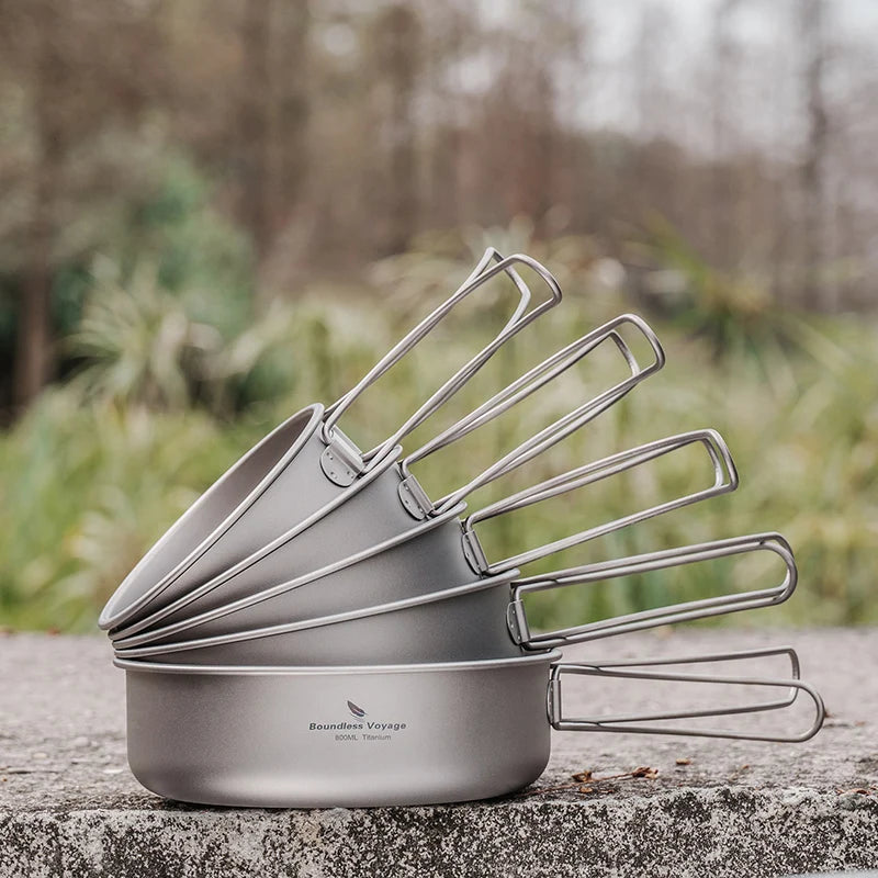 Stack of camping cookware on a stone surface with a natural background