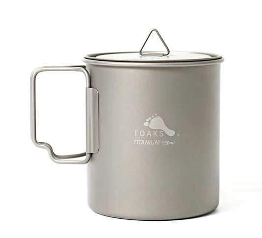 Titanium mug with handle and lid on a white background, featuring the Toaks Titanium logo.