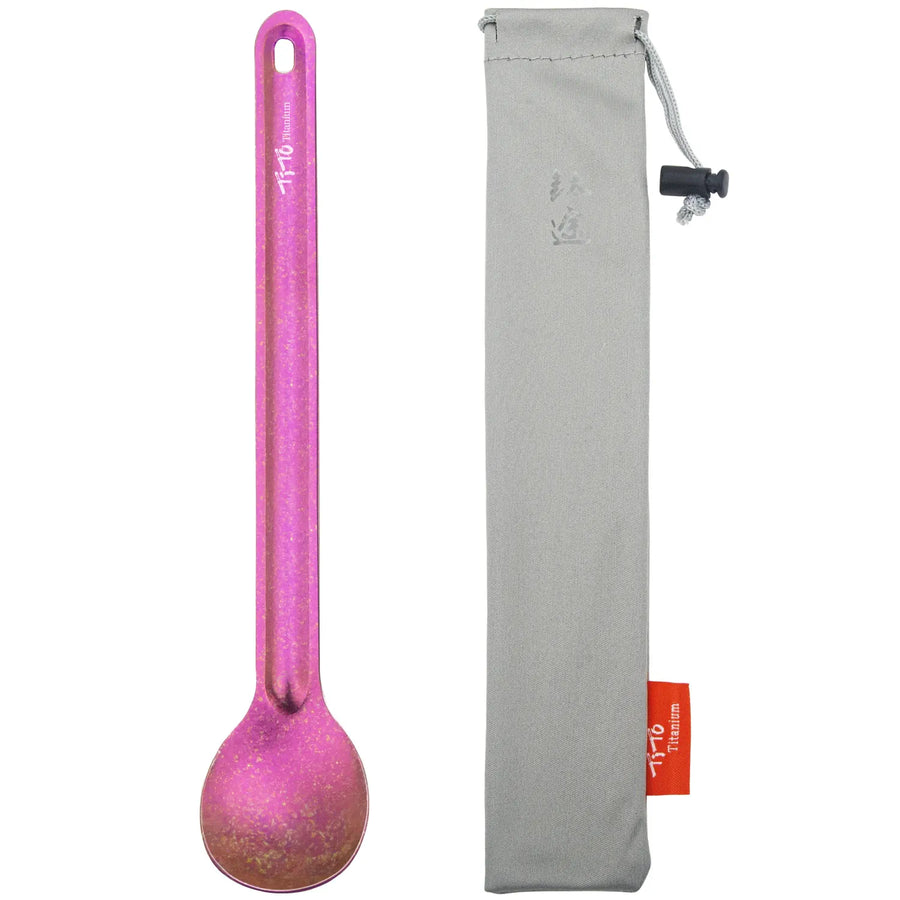 Pink spoon with a gray carrying case on a white background