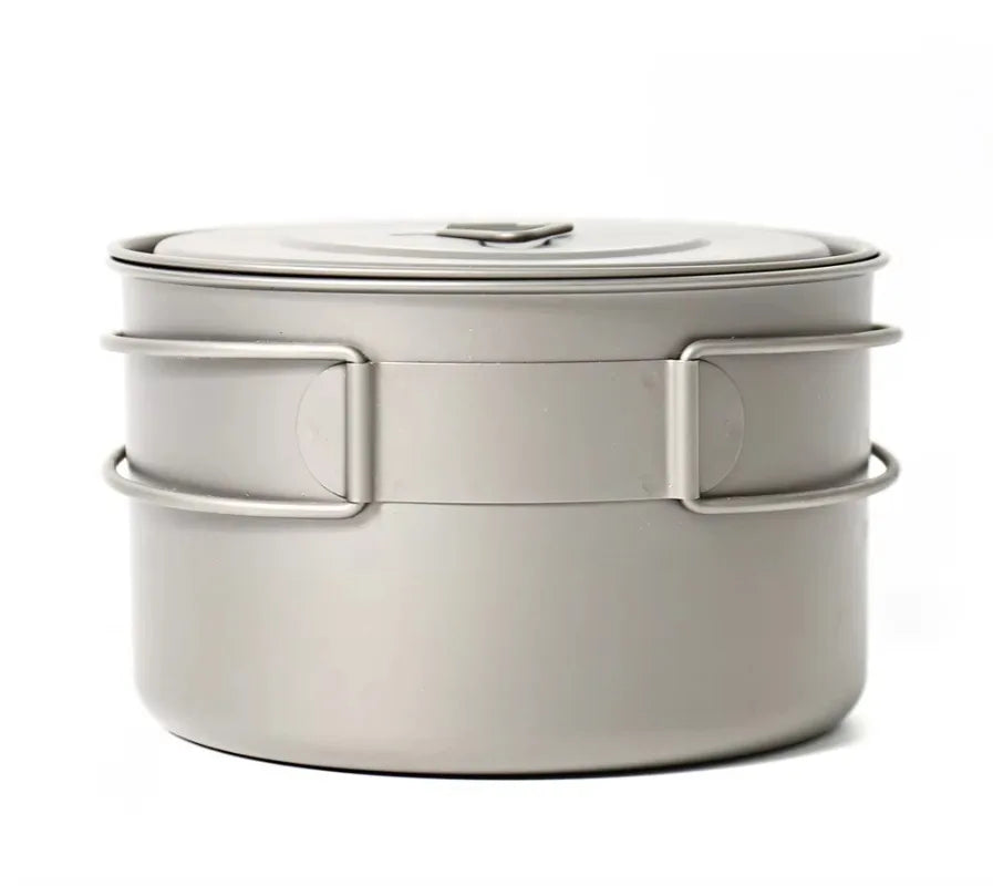 Metallic camping pot with lid on a white background