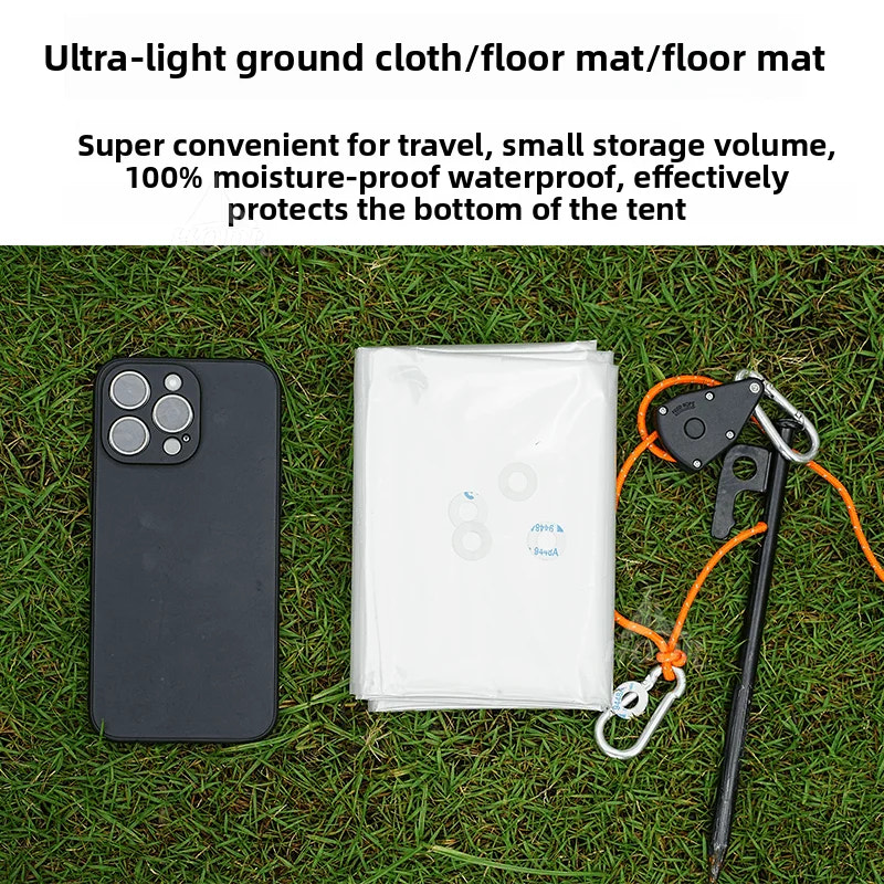 Ultra-light ground cloth/floor mat on grass with phone and tent stakes for scale