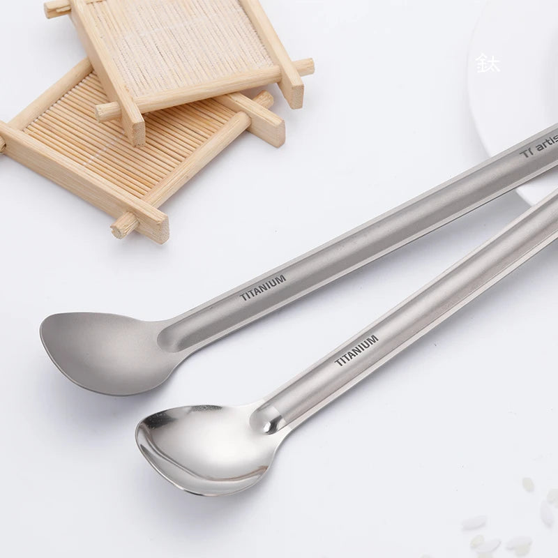 Two titanium spoons with 'Titanium' branding on a white background
