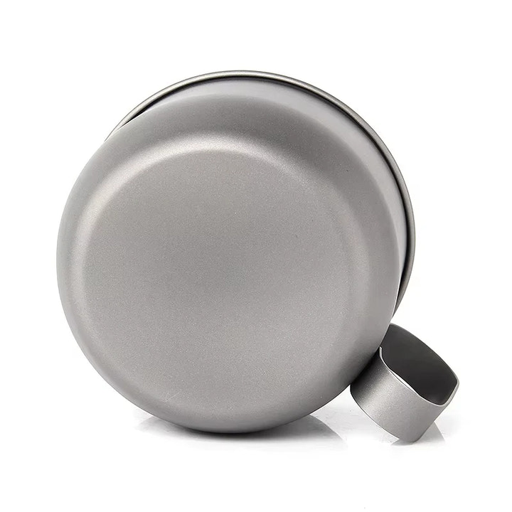 Silver metal cup with handle on a white background