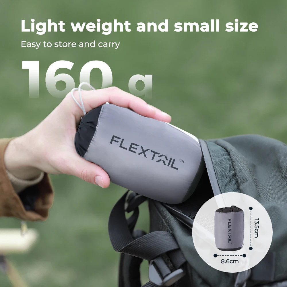 Person holding a gray 'FLEXTAIL' product with text about weight and size on a green background