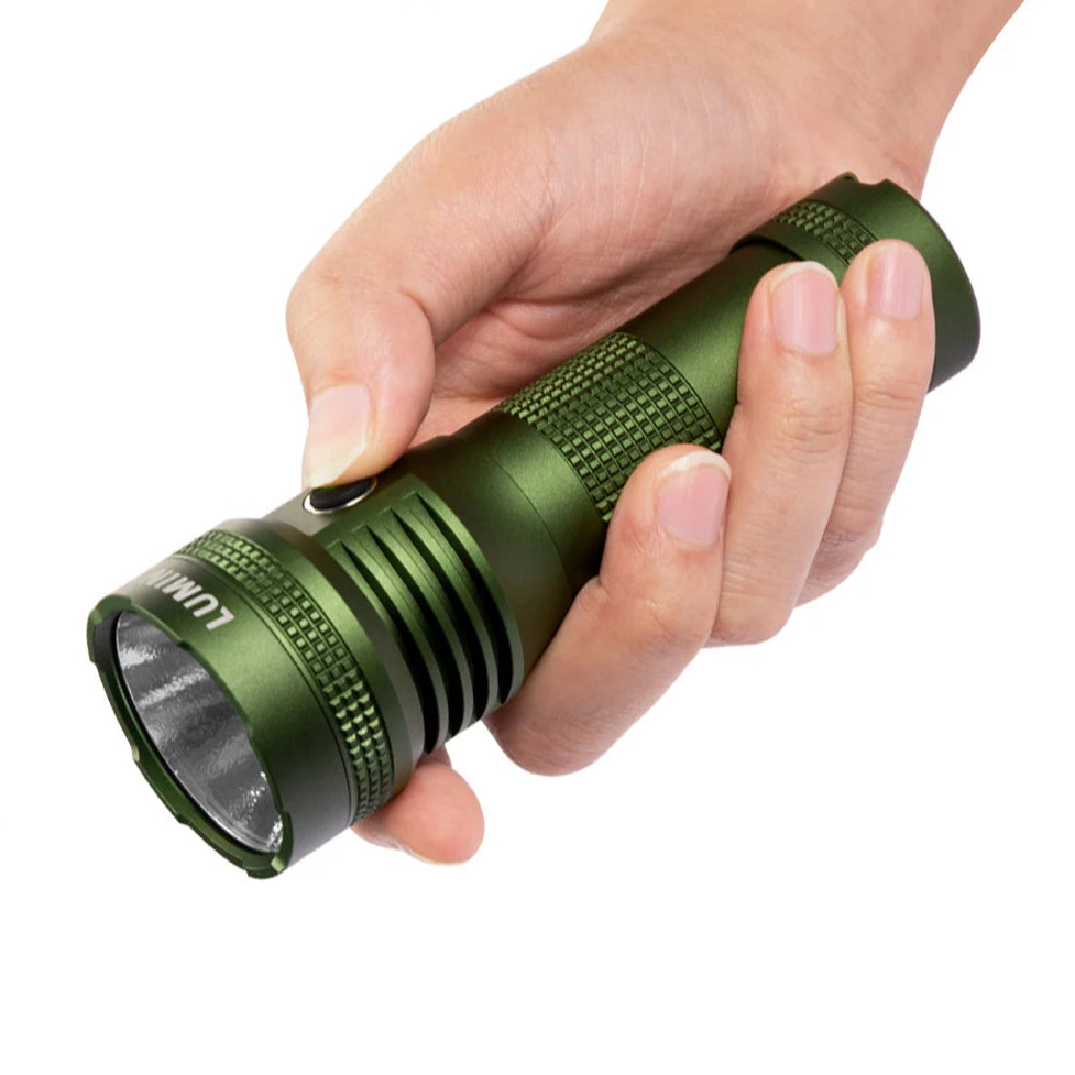 Hand holding a green flashlight against a white background
