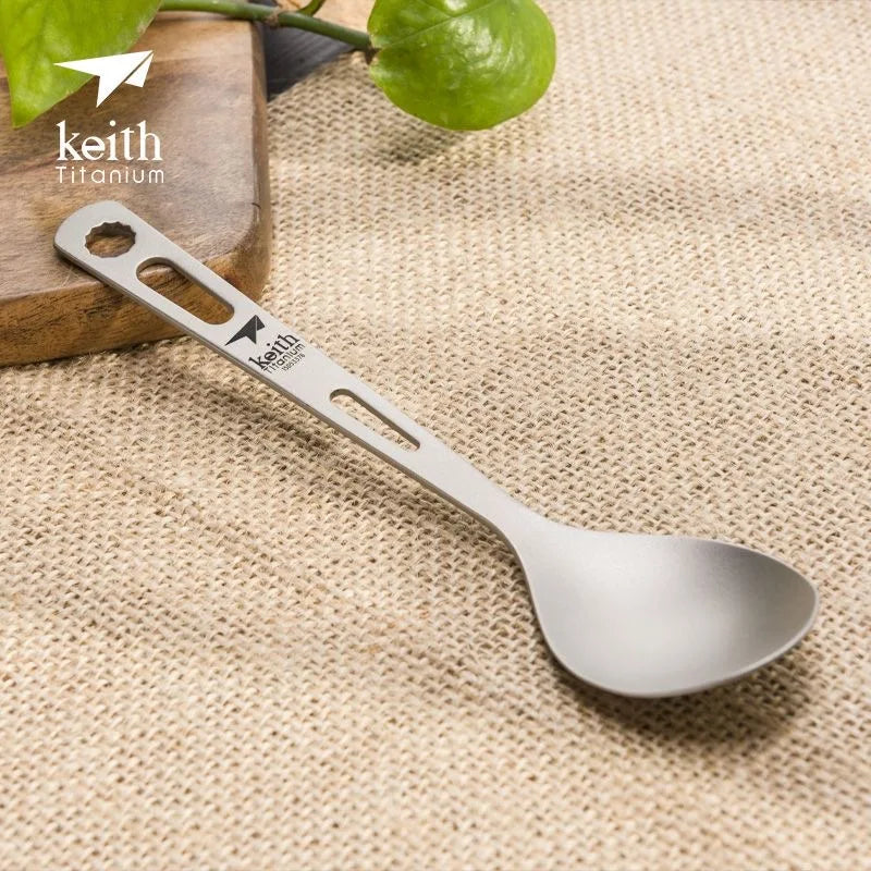 titanium spoon with Keith Titanium logo on a textured fabric background