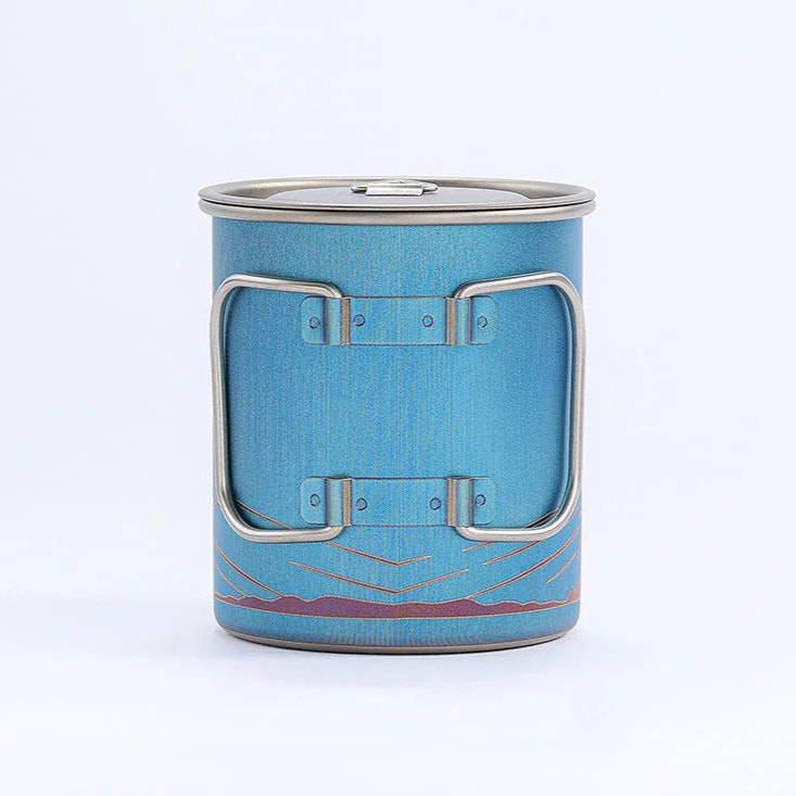 Blue metal cup with silver handles on a white background