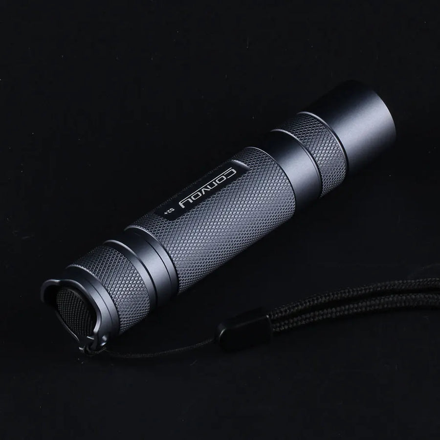 Black flashlight with brand name on a black background