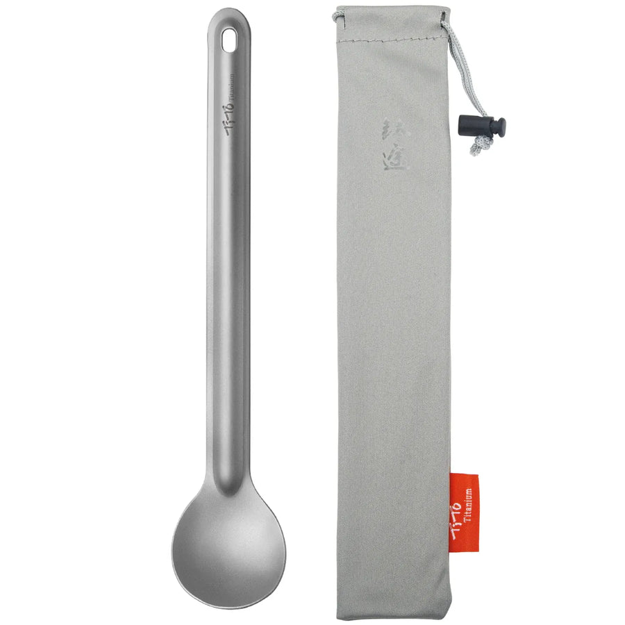 Silver spoon with a gray carrying case on a white background