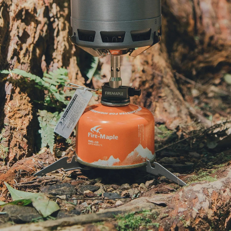 Camp stove with Fire-Maple fuel canister on a natural background