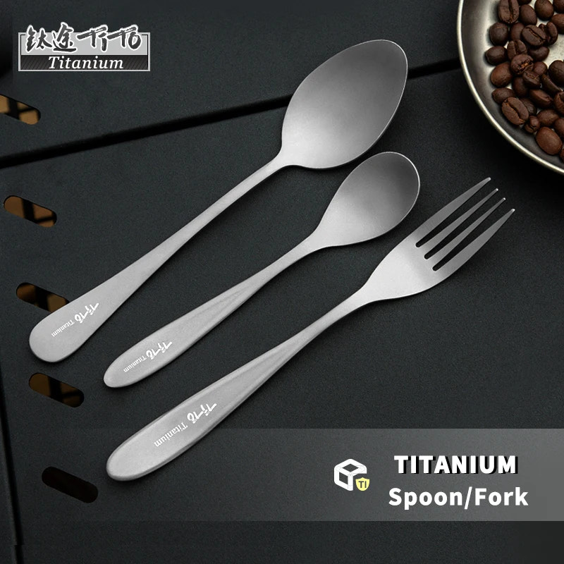 titanium spoon and fork set on a dark surface with 'Titanium' branding.