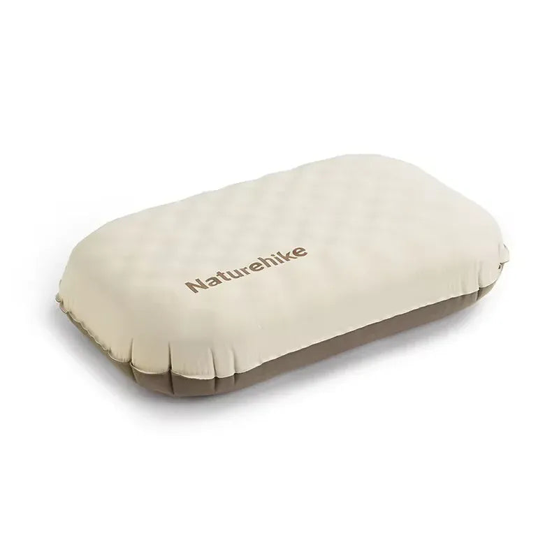 Beige inflatable pillow with 'Naturehike' branding on a white background
