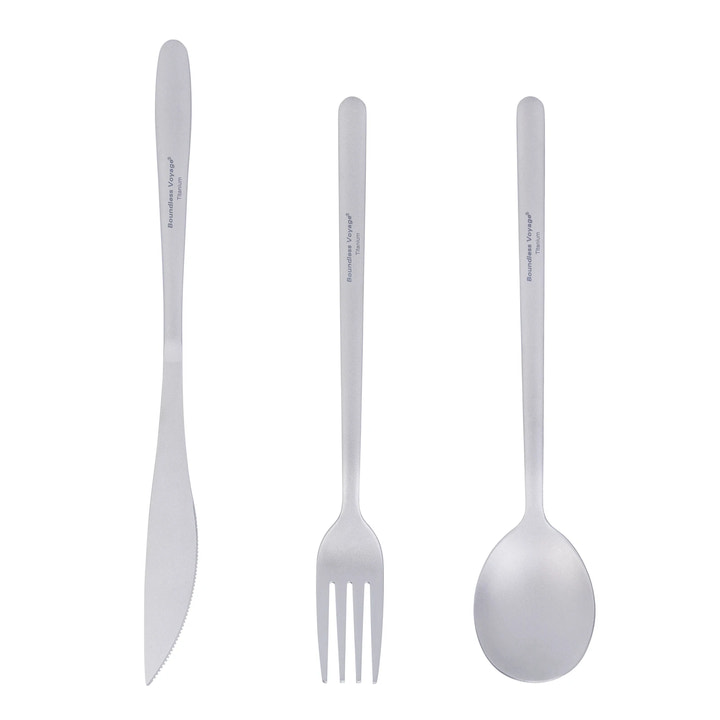 Set of titanium cutlery including a knife, fork, and spoon on a white background