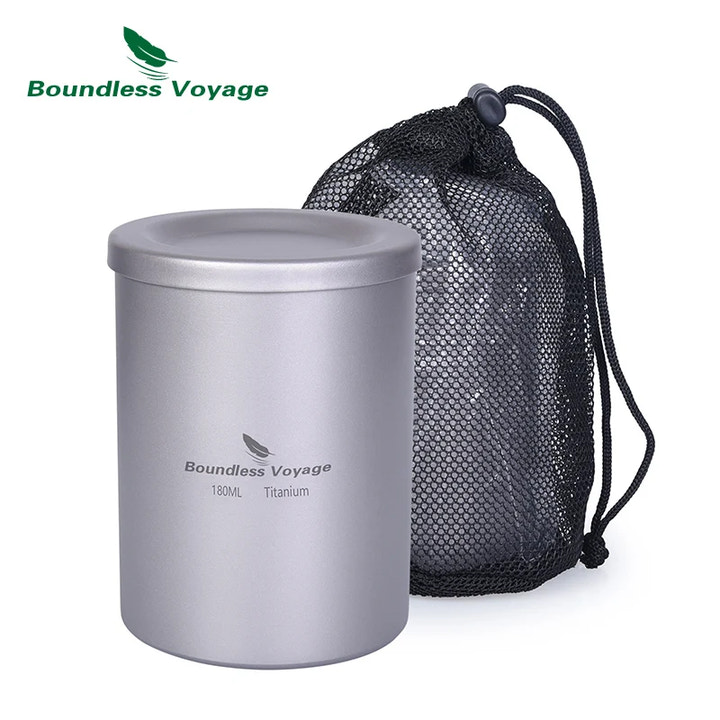 Titanium mug with drawstring bag on a white background, featuring Boundless Voyage branding.