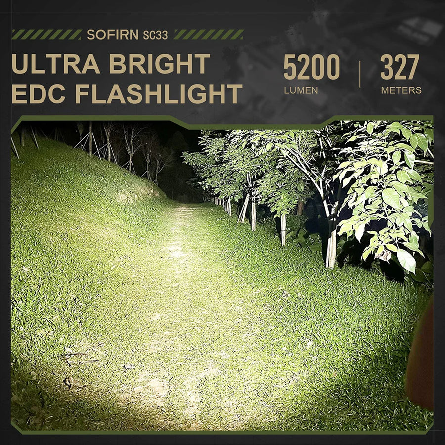 SOFIRN SC33 ultra bright EDC flashlight illuminating a grassy area at night.