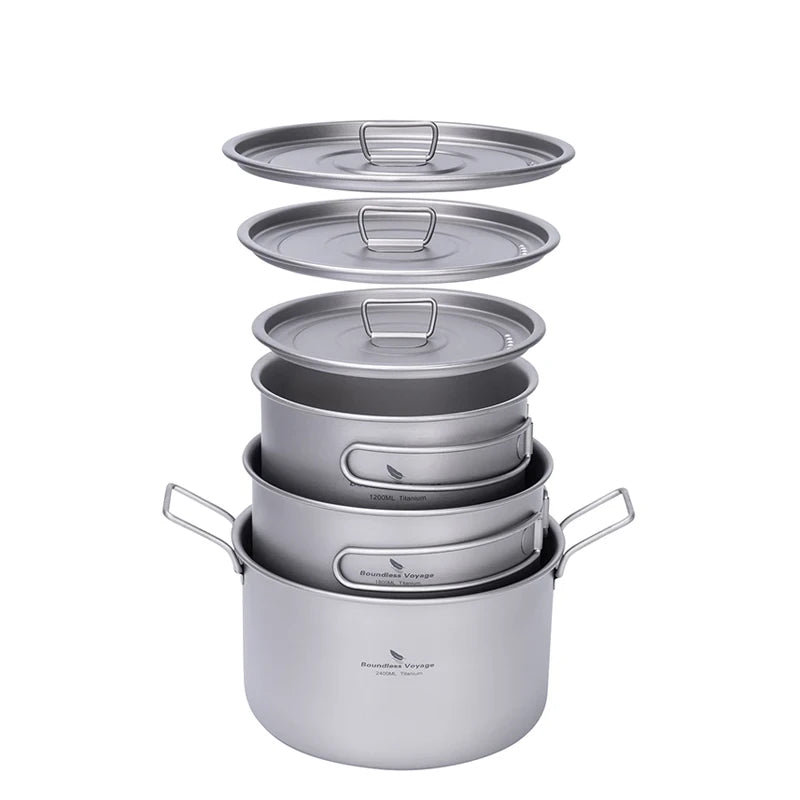 Set of titanium cookware with lids on a white background
