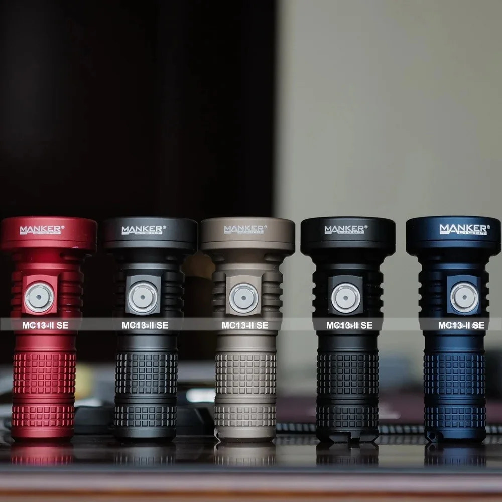 Five MANKER flashlights in different colors arranged on a reflective surface.