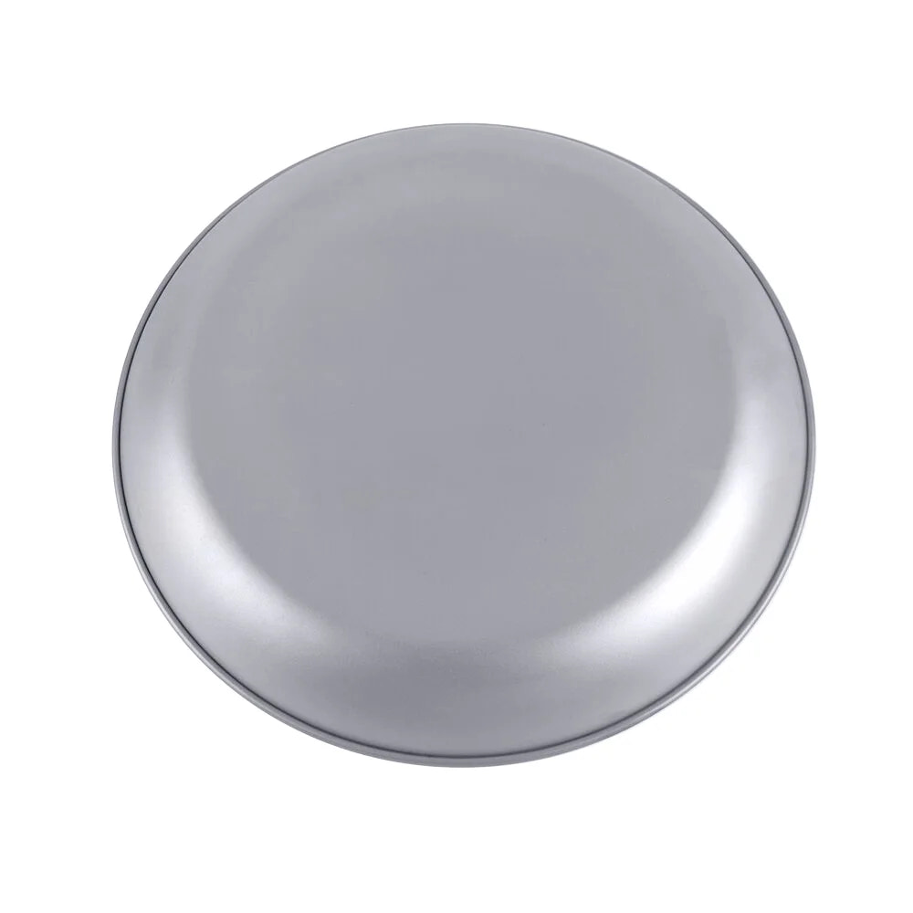 Round metallic object on a white background