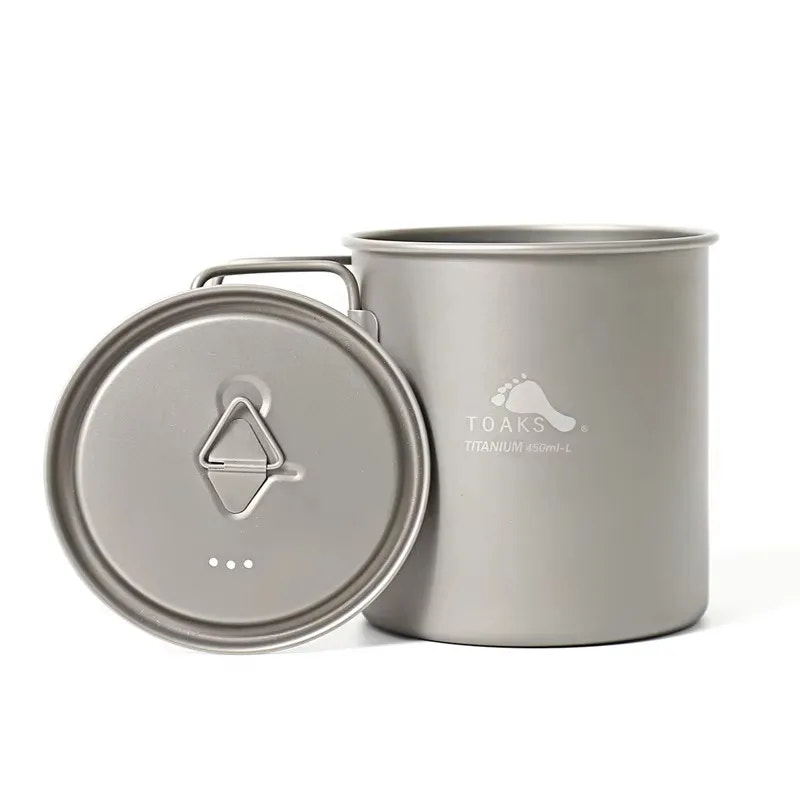 Titanium camping pot with lid on a white background