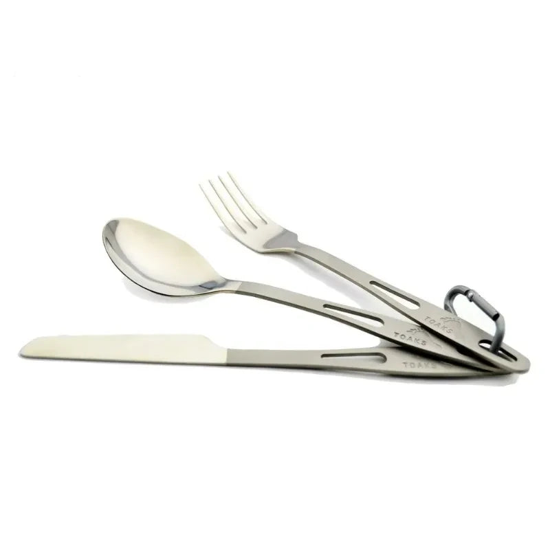 Set of folding cutlery including a knife, fork, and spoon on a white background