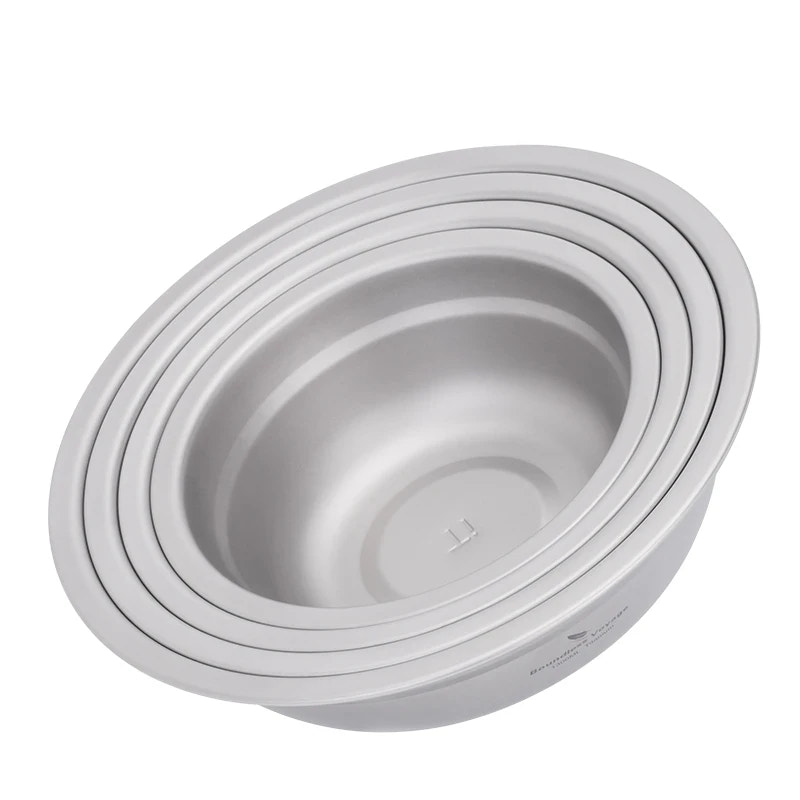 Set of titanium bowls stacked on a white background