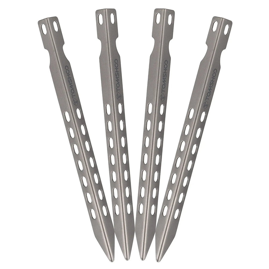 Four metal tent stakes on a white background
