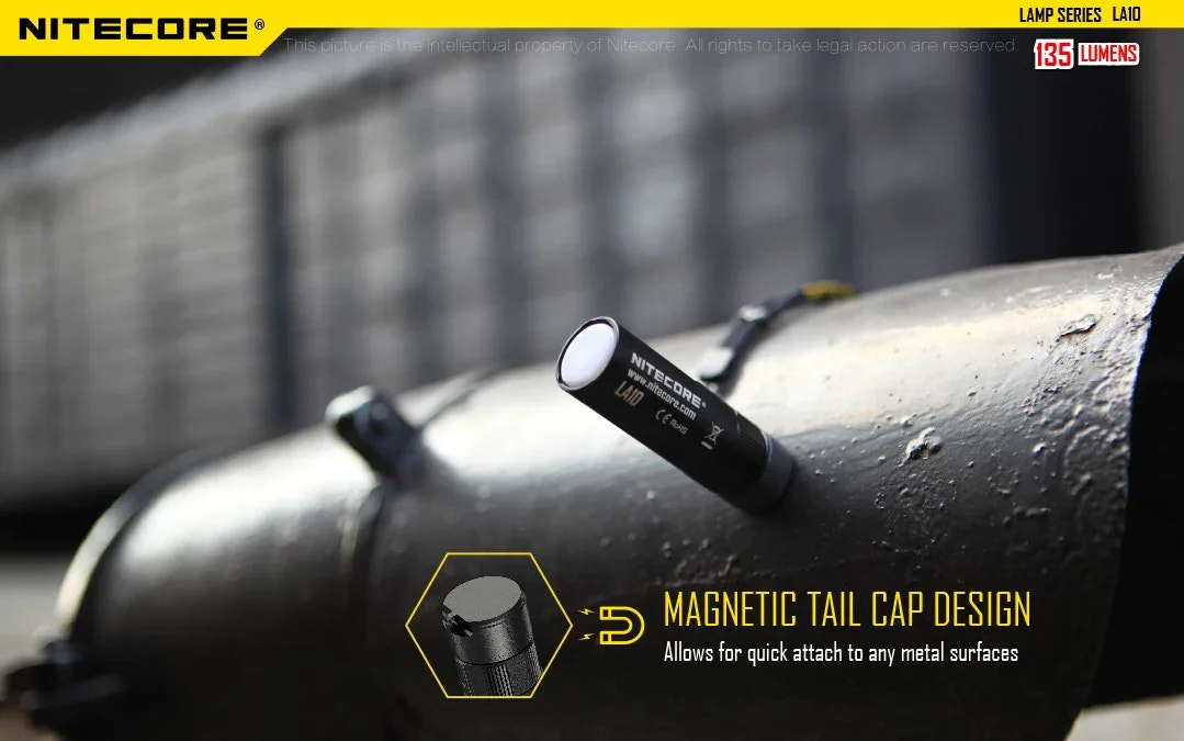 Nitecore flashlight with magnetic tail cap design on a metal surface