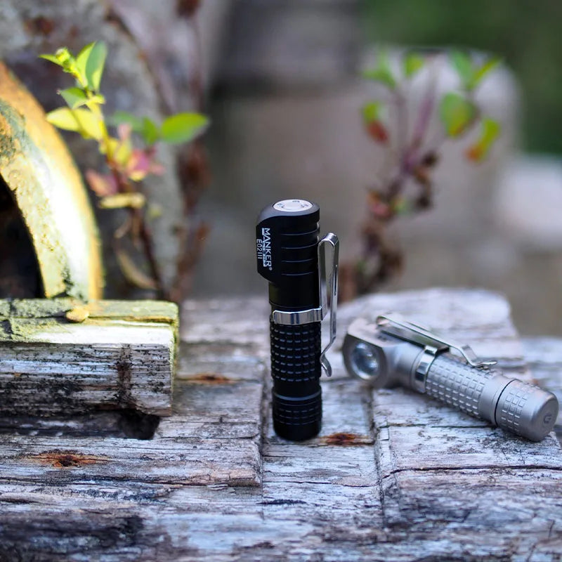 Two flashlights on a wooden surface with a natural background