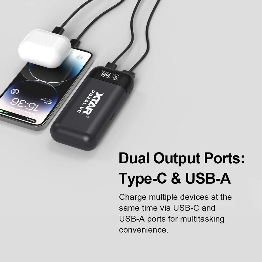 Portable power bank with dual output ports charging a smartphone on a light gray background