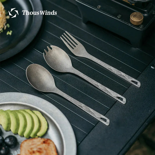 Set of gray cutlery on a dark surface with 'ThousWinds' branding.