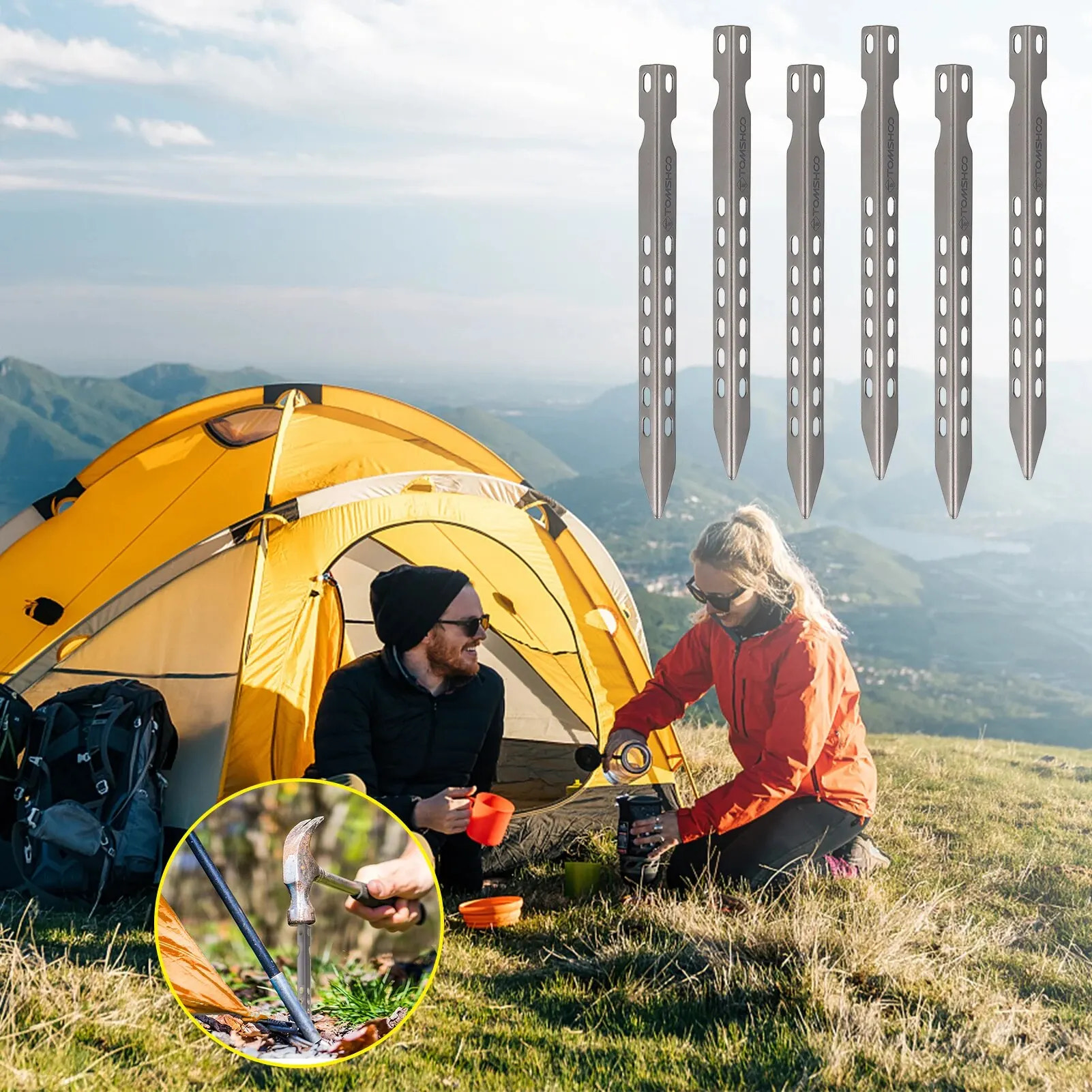 Two people camping with a yellow tent and metal tent stakes against a mountainous landscape.