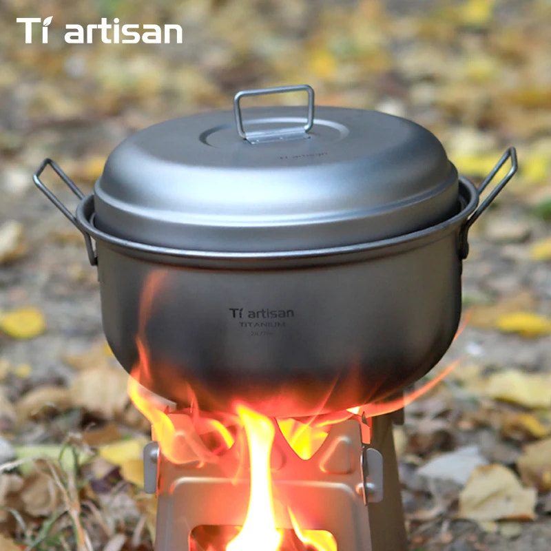 Tiartisan camping pot on a stove with flames against a natural background