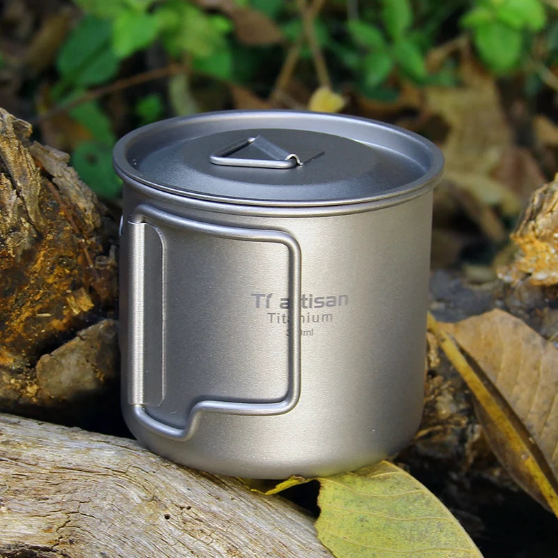 Titanium mug with lid on a natural background
