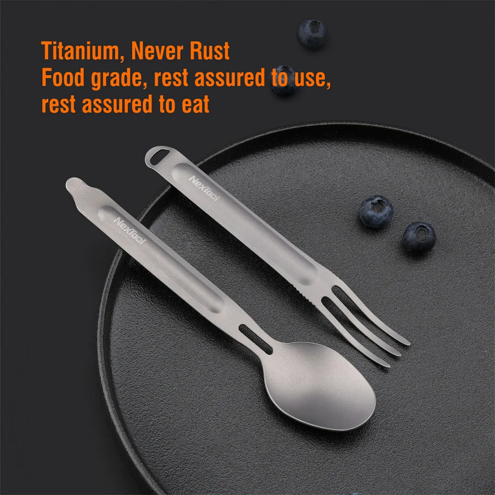 Titanium spork set on a dark surface with blueberries, featuring text about material and quality.