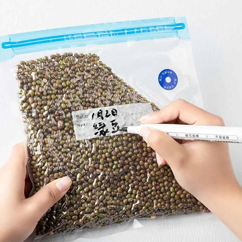 Hand writing on a package of green seeds with a pen
