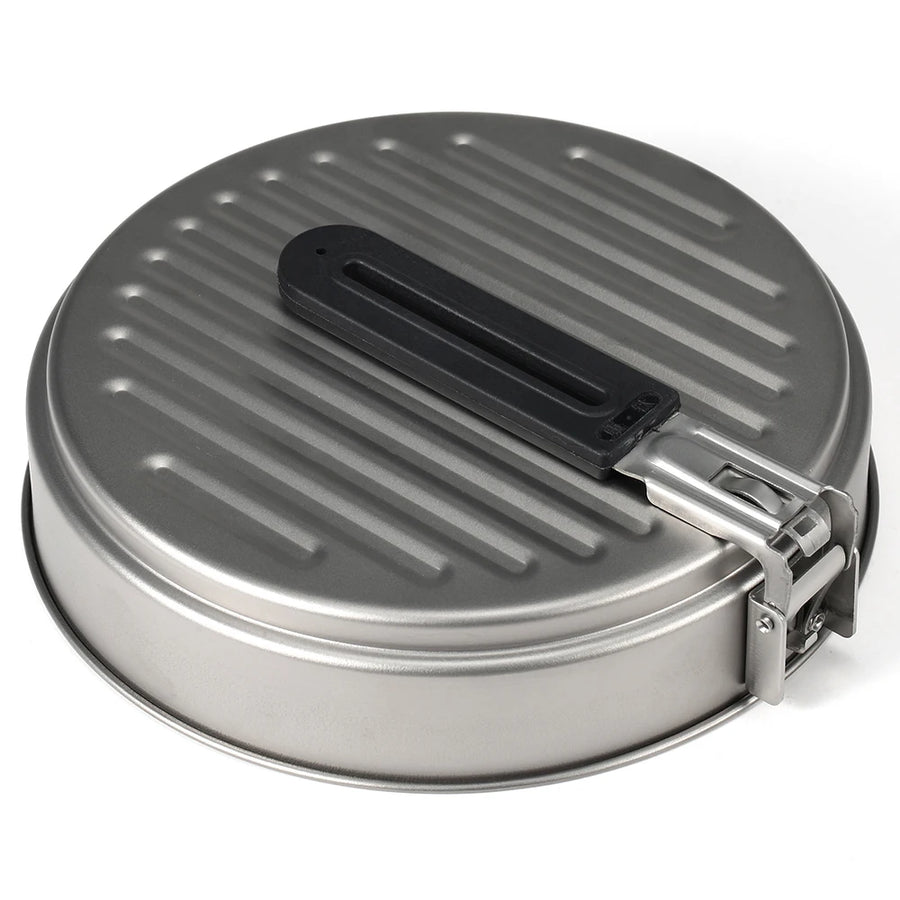 Metallic round pan with black handle on a white background
