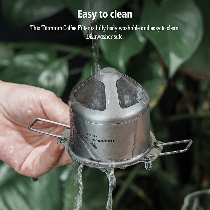 Titanium coffee filter being rinsed with water against a green leafy background