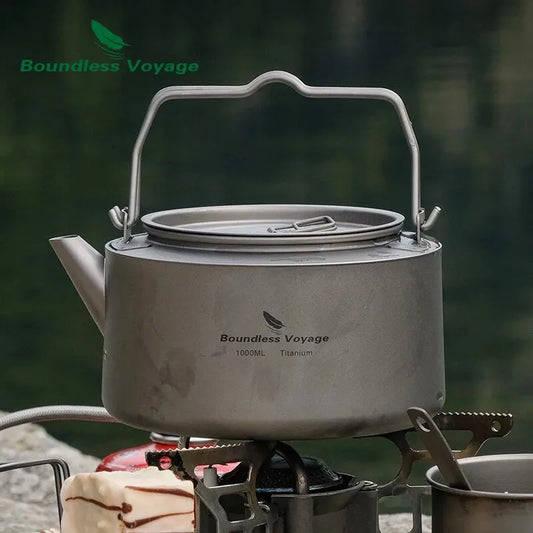 titanium kettle on a camping stove with 'Boundless Voyage' branding against a natural background.
