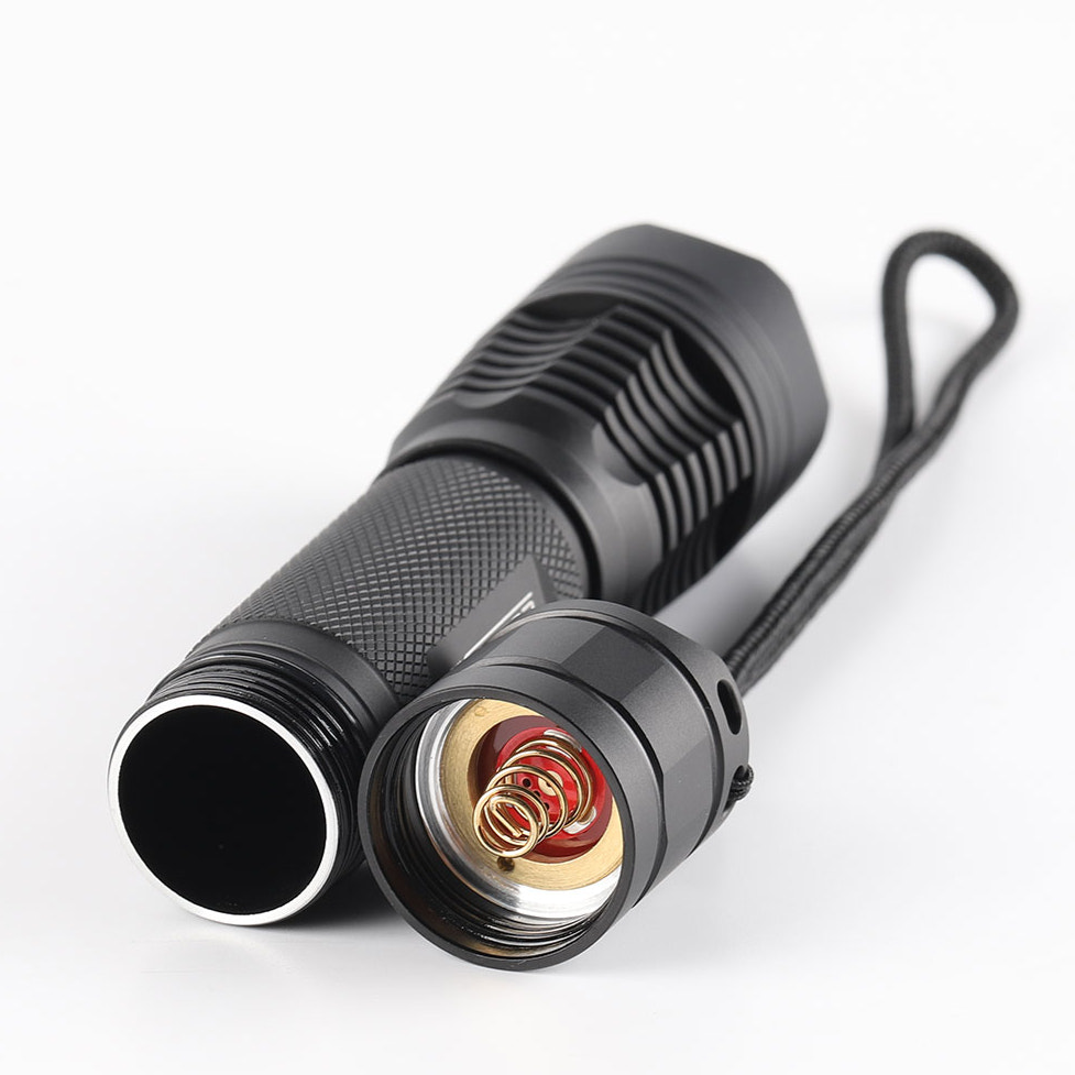 Black flashlight with detailed design on a white background