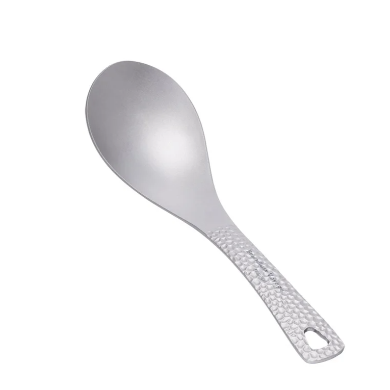 Metallic spoon with textured handle on a white background