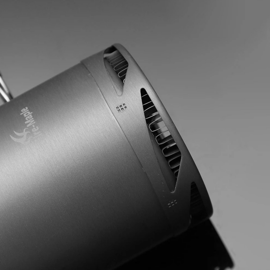 Close-up of a metallic device with a brand logo on a gray background