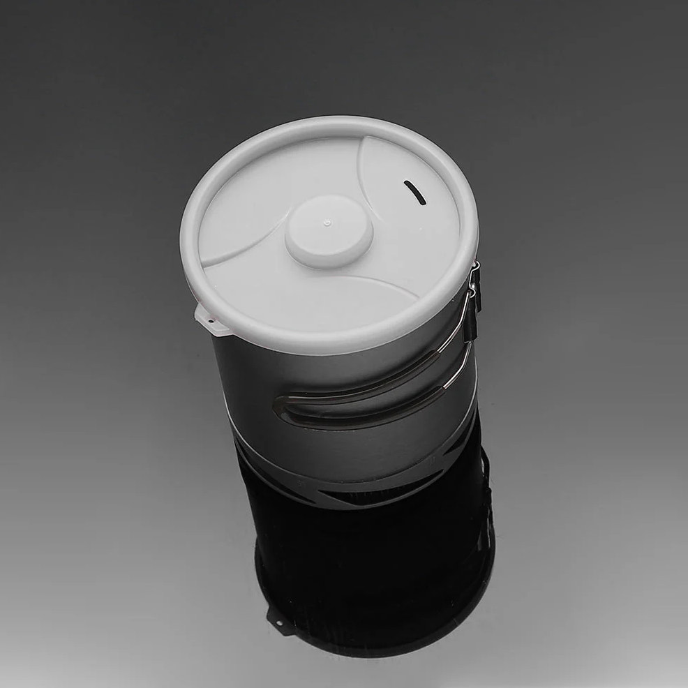 Black and white cylindrical container with a lid on a gray background