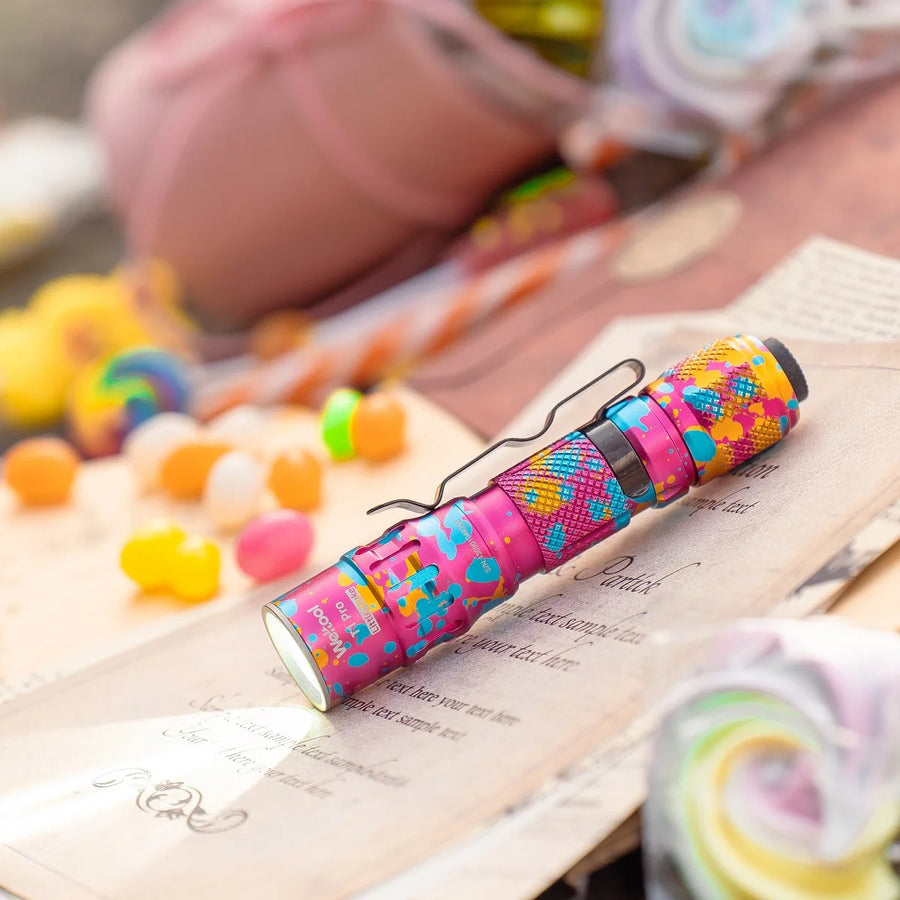 Colorful flashlight on an open book with a blurred background